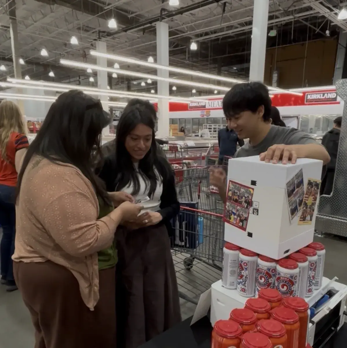 Guests taking four-cut photos with a my4cut mini booth at an event